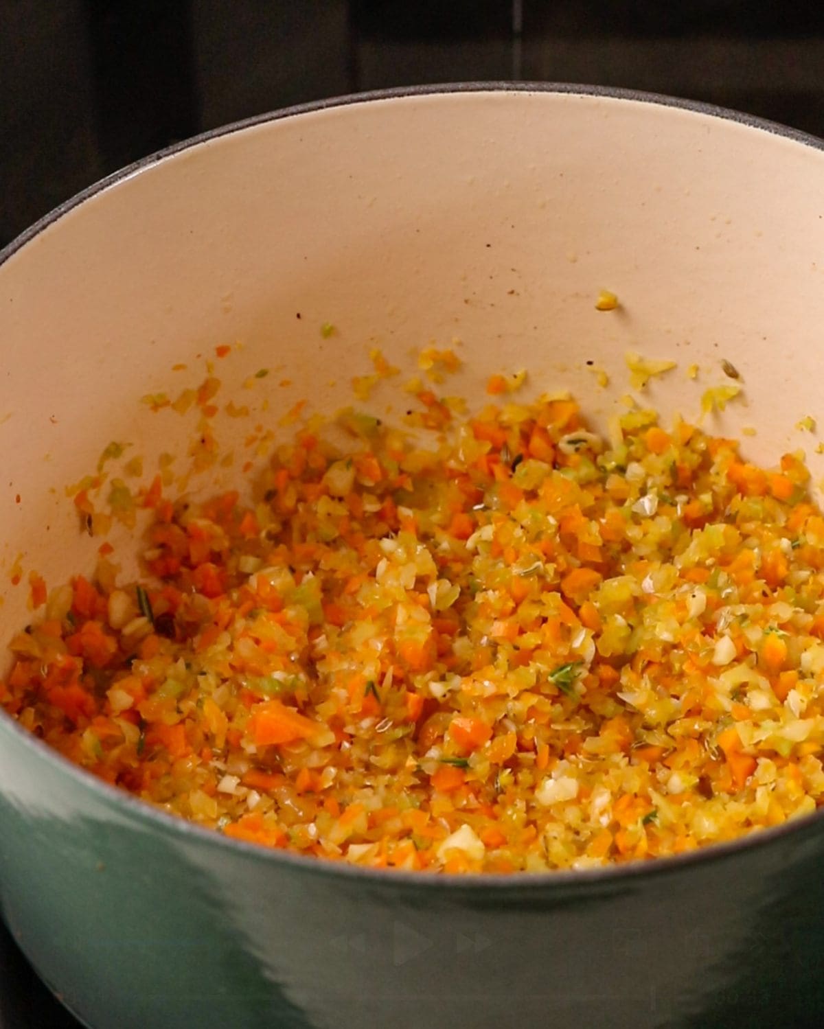 Celery, onion and carrot mixture frying in the pot.