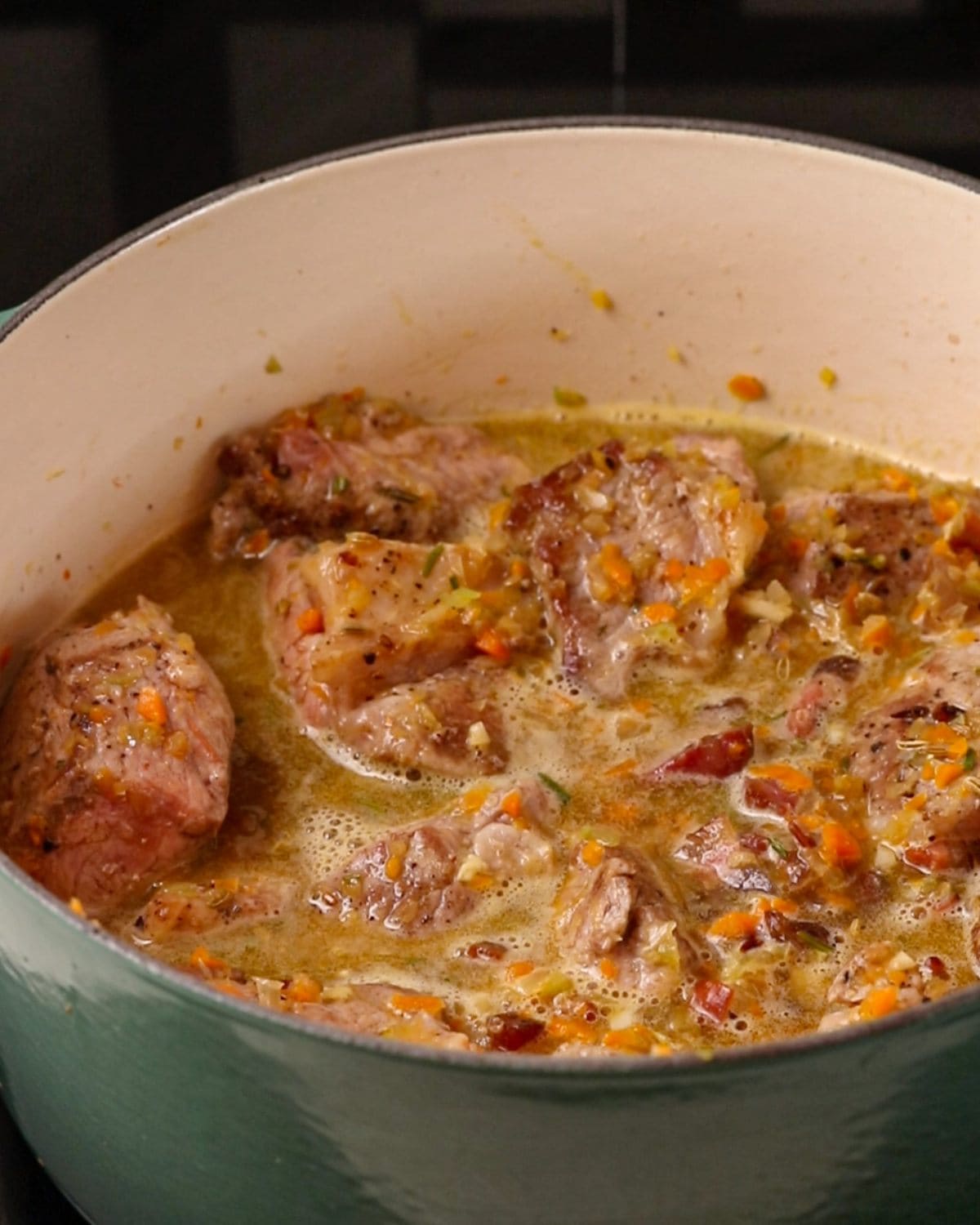 Pork chunks in the soffritto mixture with wine reducing.