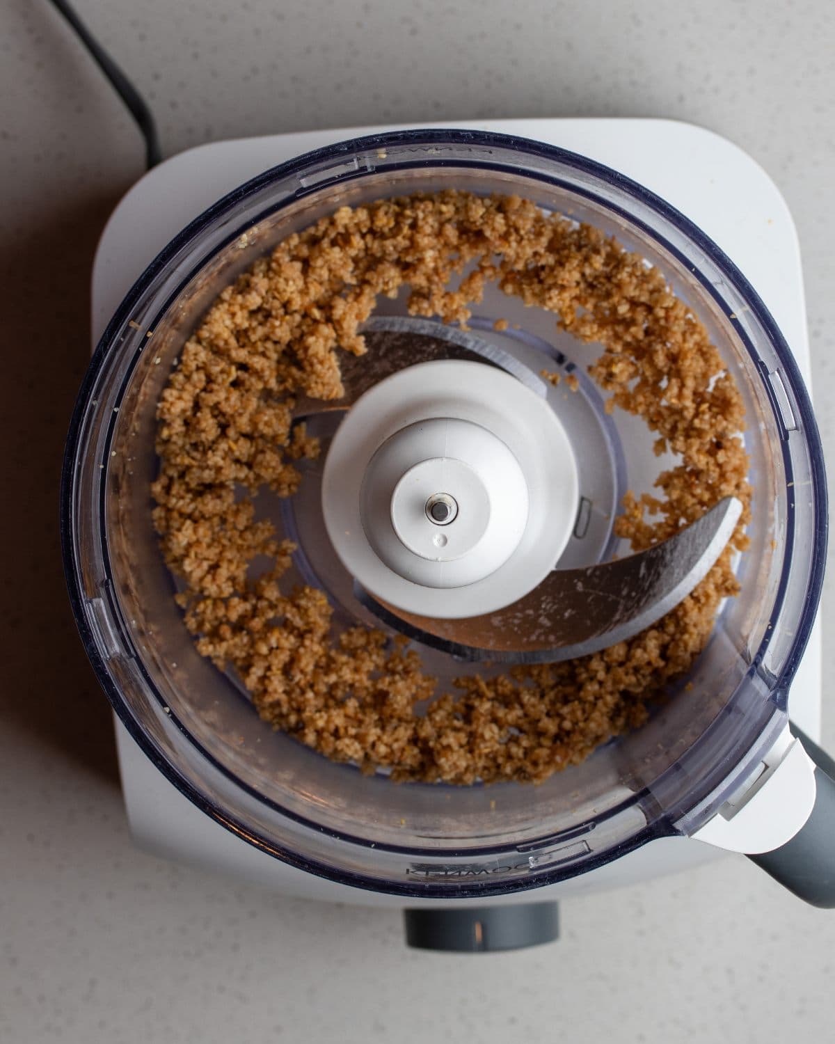 Food processor with blended pine nuts.