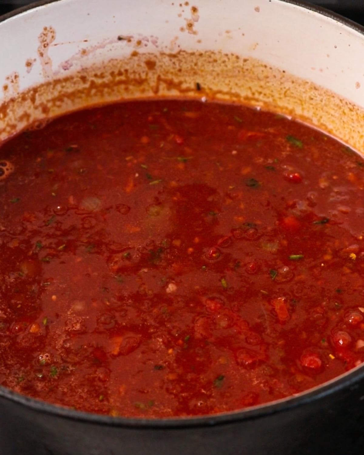 Red wine, tomatoes and stock simmering for beef cheek ragu.