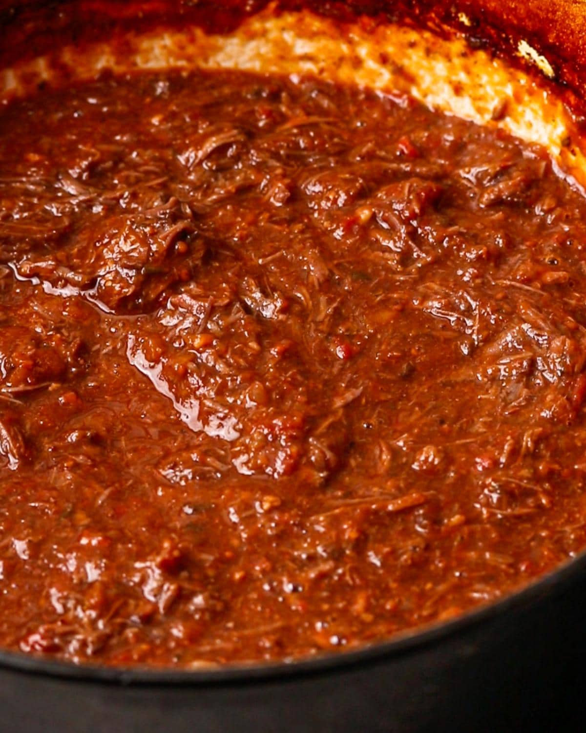 Finished beef cheek ragu with shredded beef stirred through the sauce.