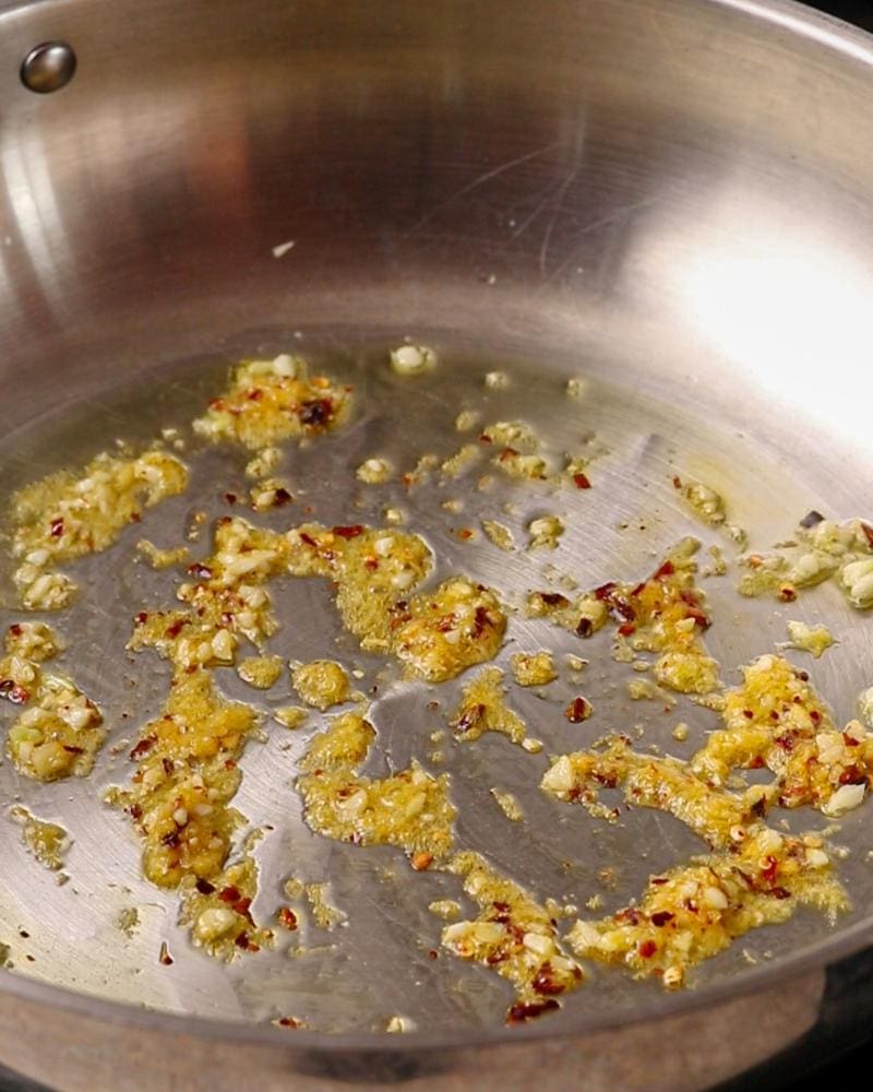 Zest and red pepper flakes sizzling in the pan.