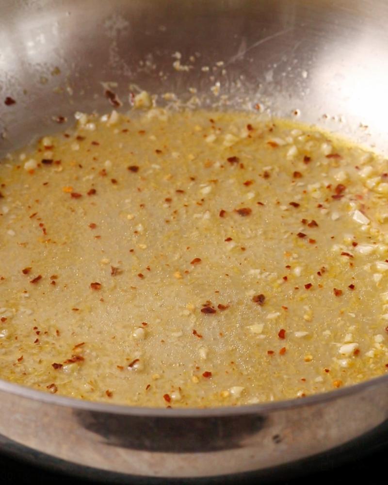 Pasta water simmering in the garlic mixture.