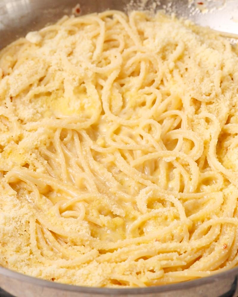 Grated parmesan sprinkled and melting on top of pasta.