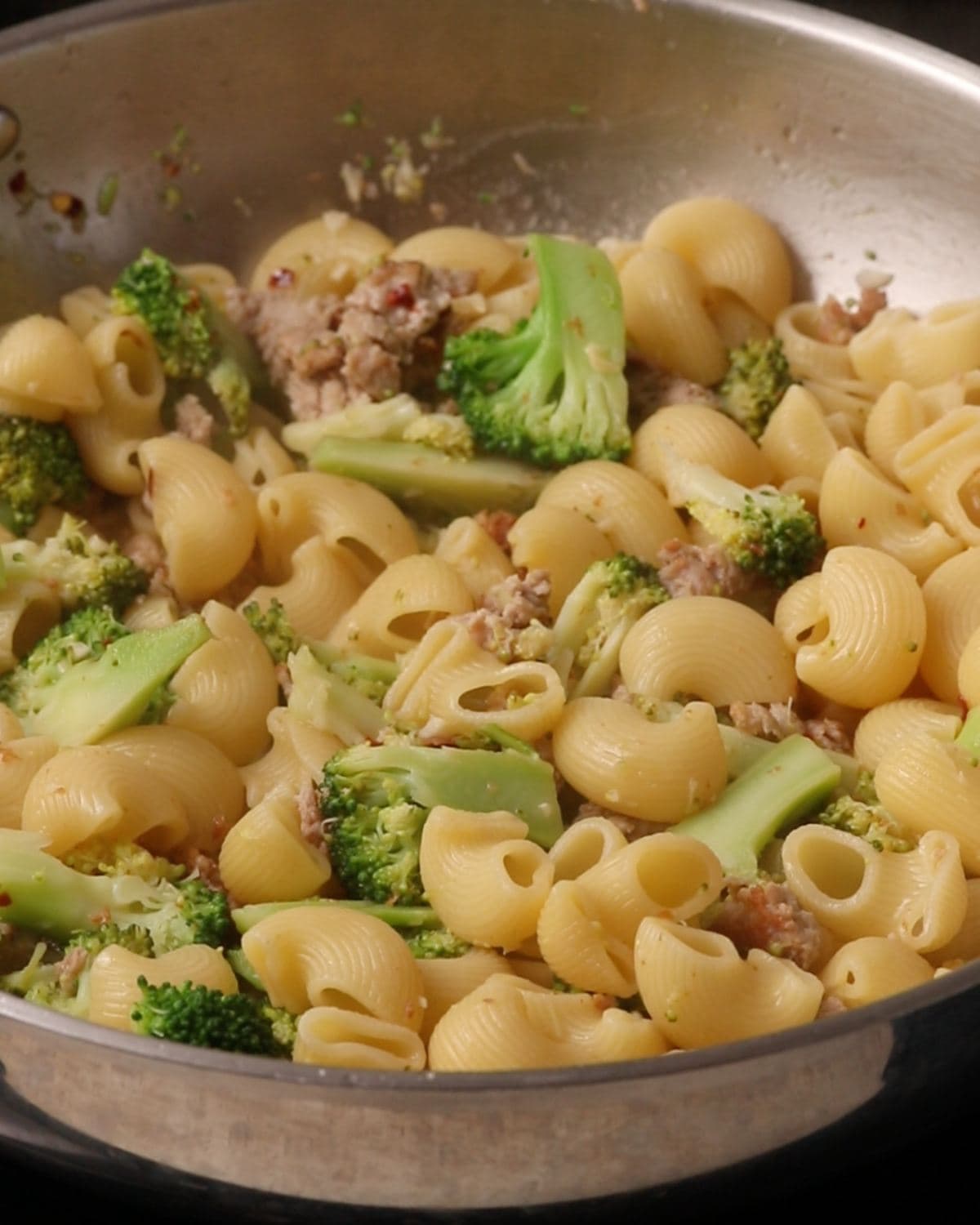 Cooked pasta added into the pan and mixed through.