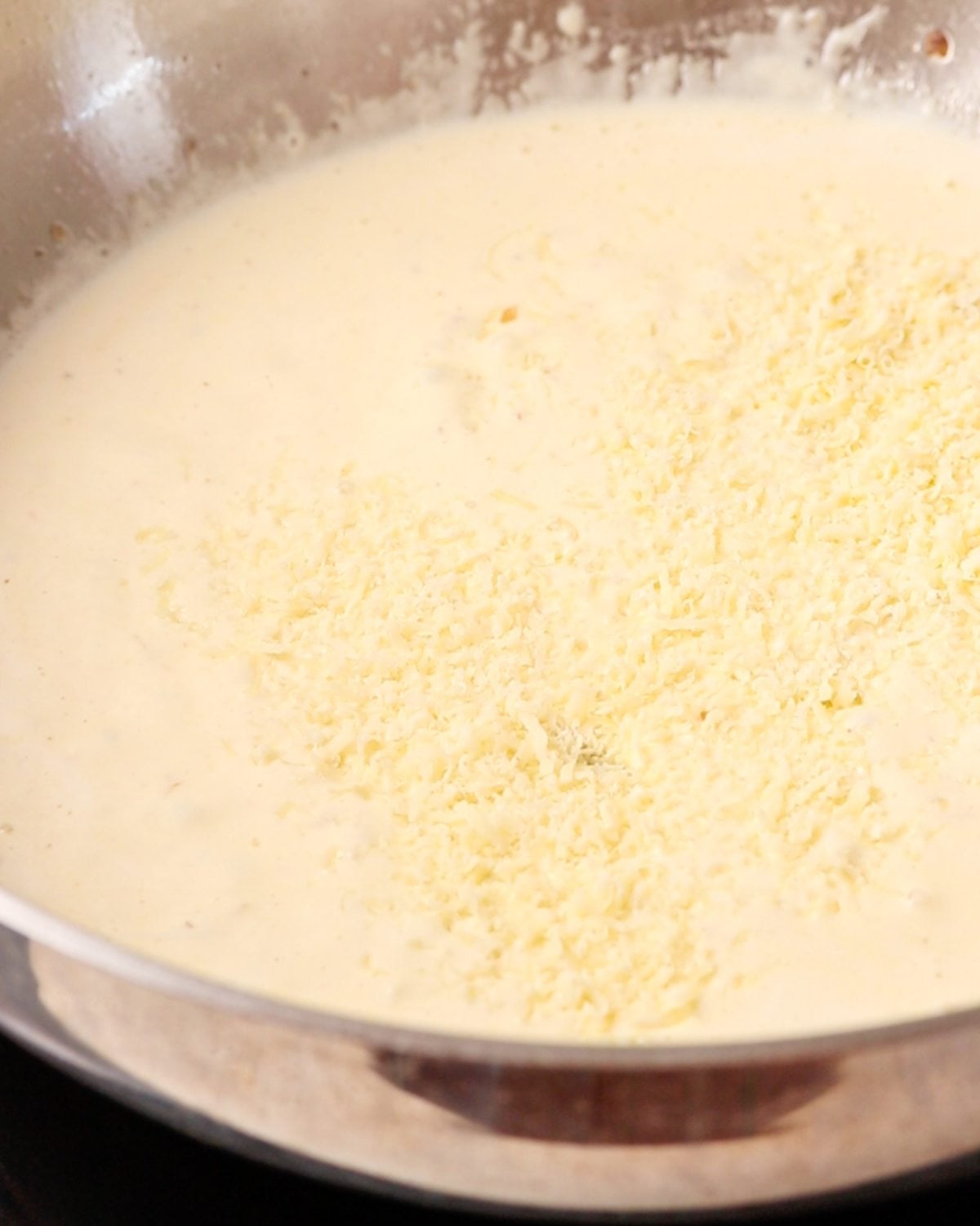 Grated parmesan cheese sprinkled on top of cream.