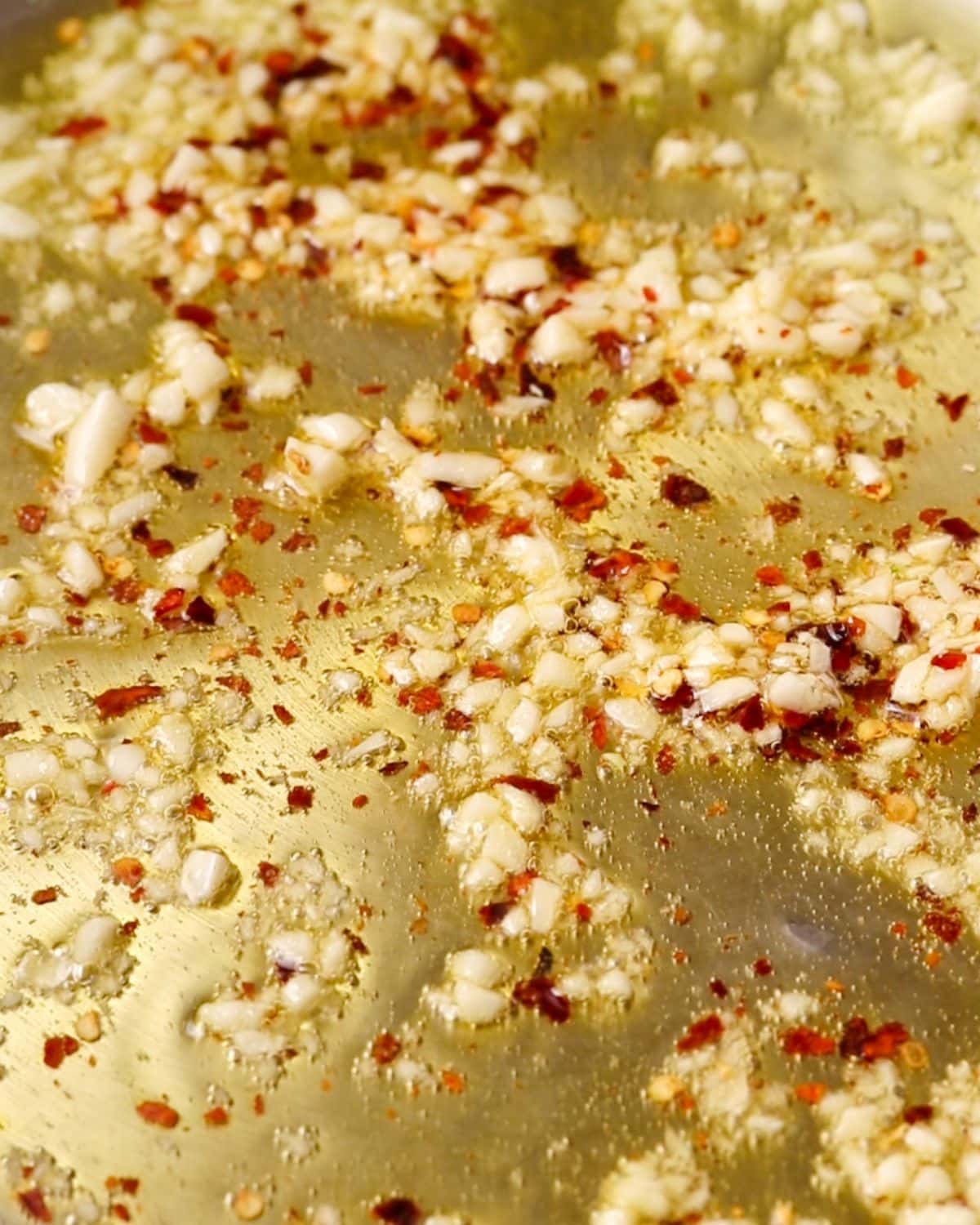 Garlic and red pepper flakes sizzling in the fry pan.