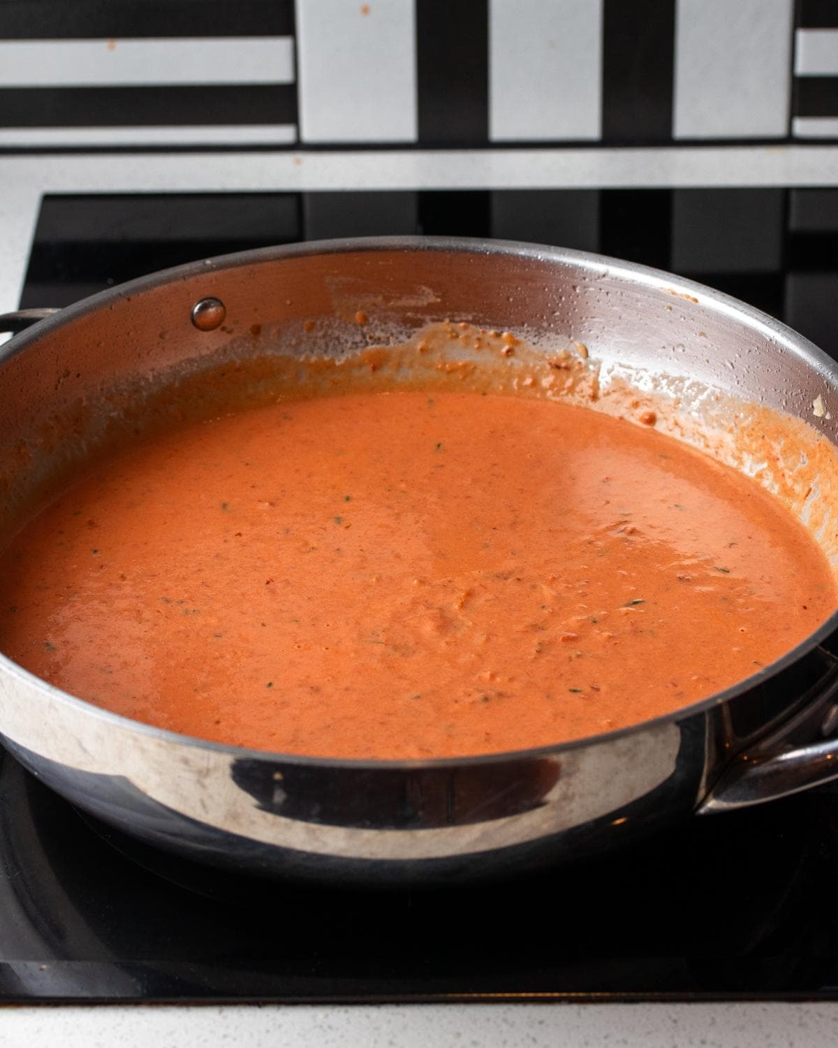 Cream and tomato passata added in to pan to create a thick sauce.