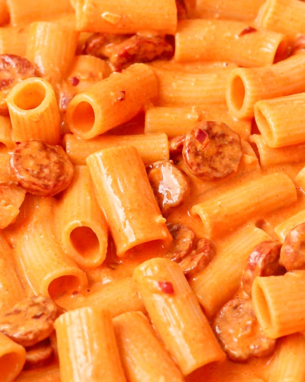 Cooked rigatoni pasta mixed through the sauce.