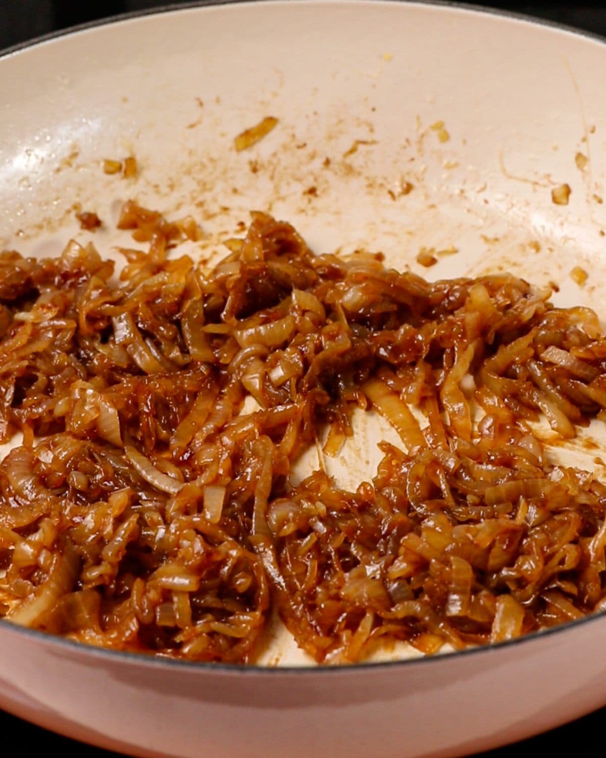 Caramelized onions, golden and reduced in the pan.
