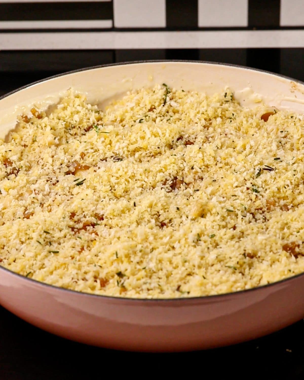 Panko breadcrumbs sprinkled on top of mac and cheese, ready for the oven.