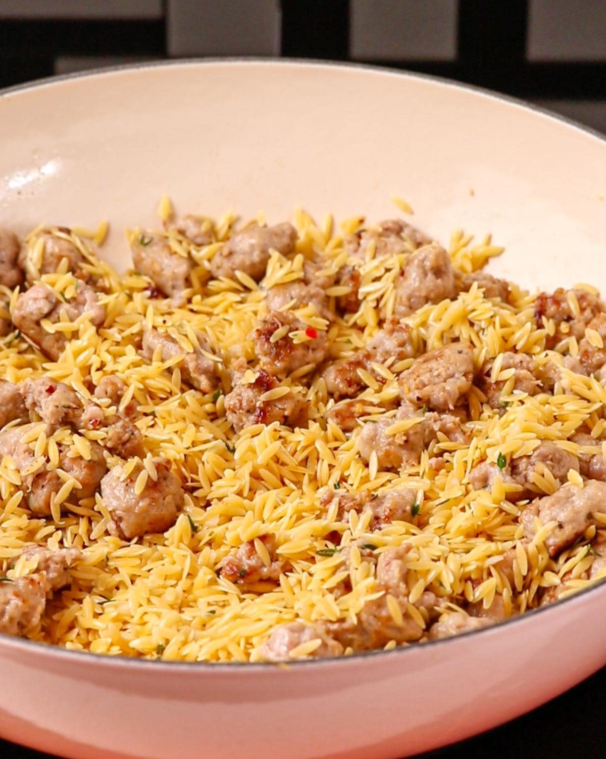 Uncooked orzo pasta mixed through.