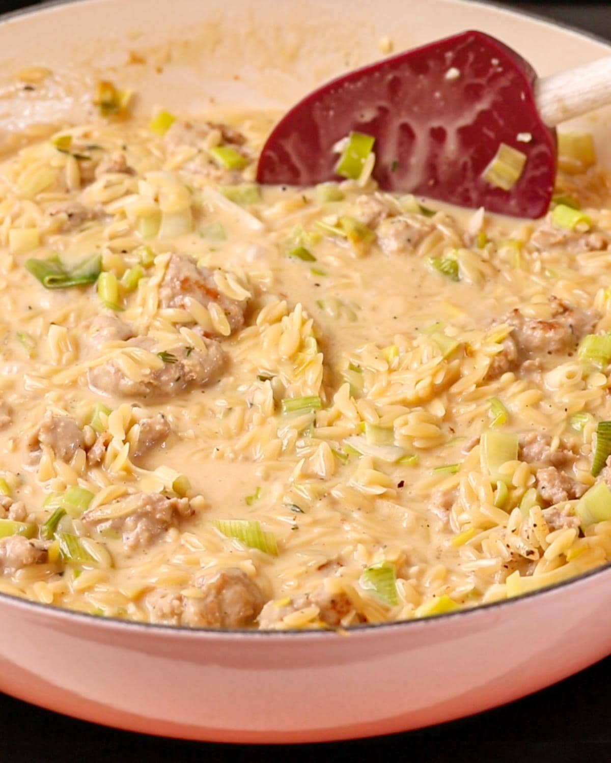 Cooked orzo bring stirred with the leeks.