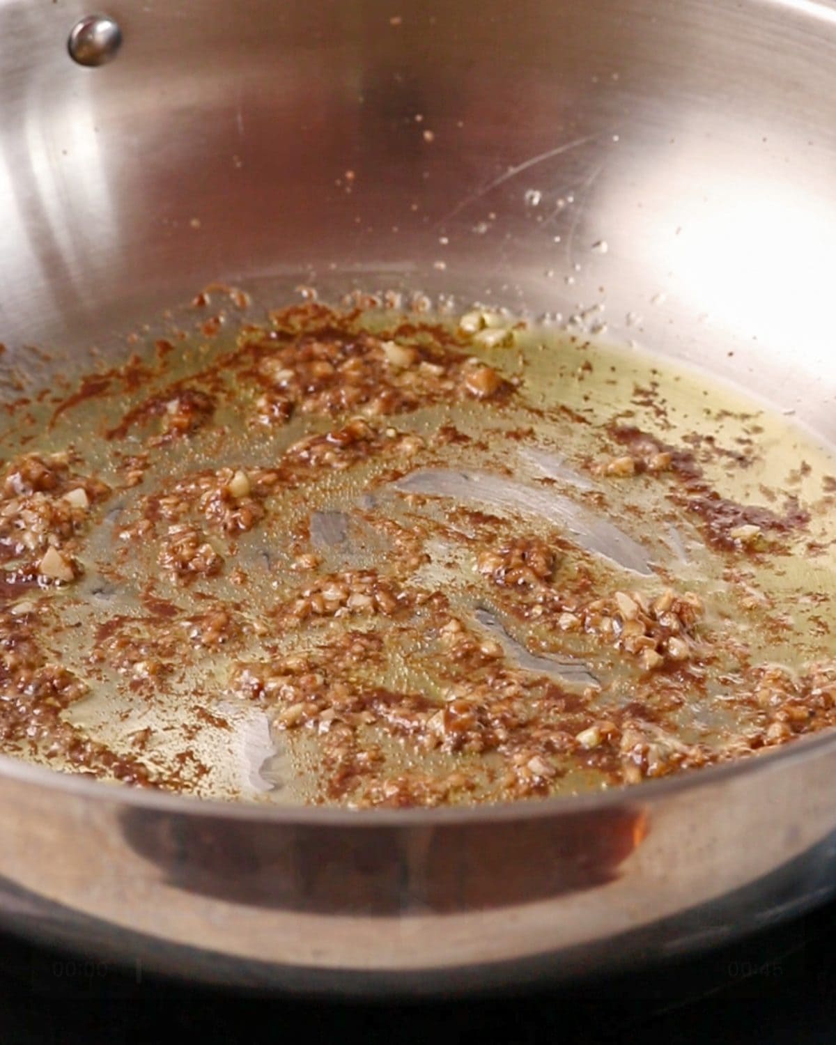 Melted anchovies sizzling with garlic in the pan. 