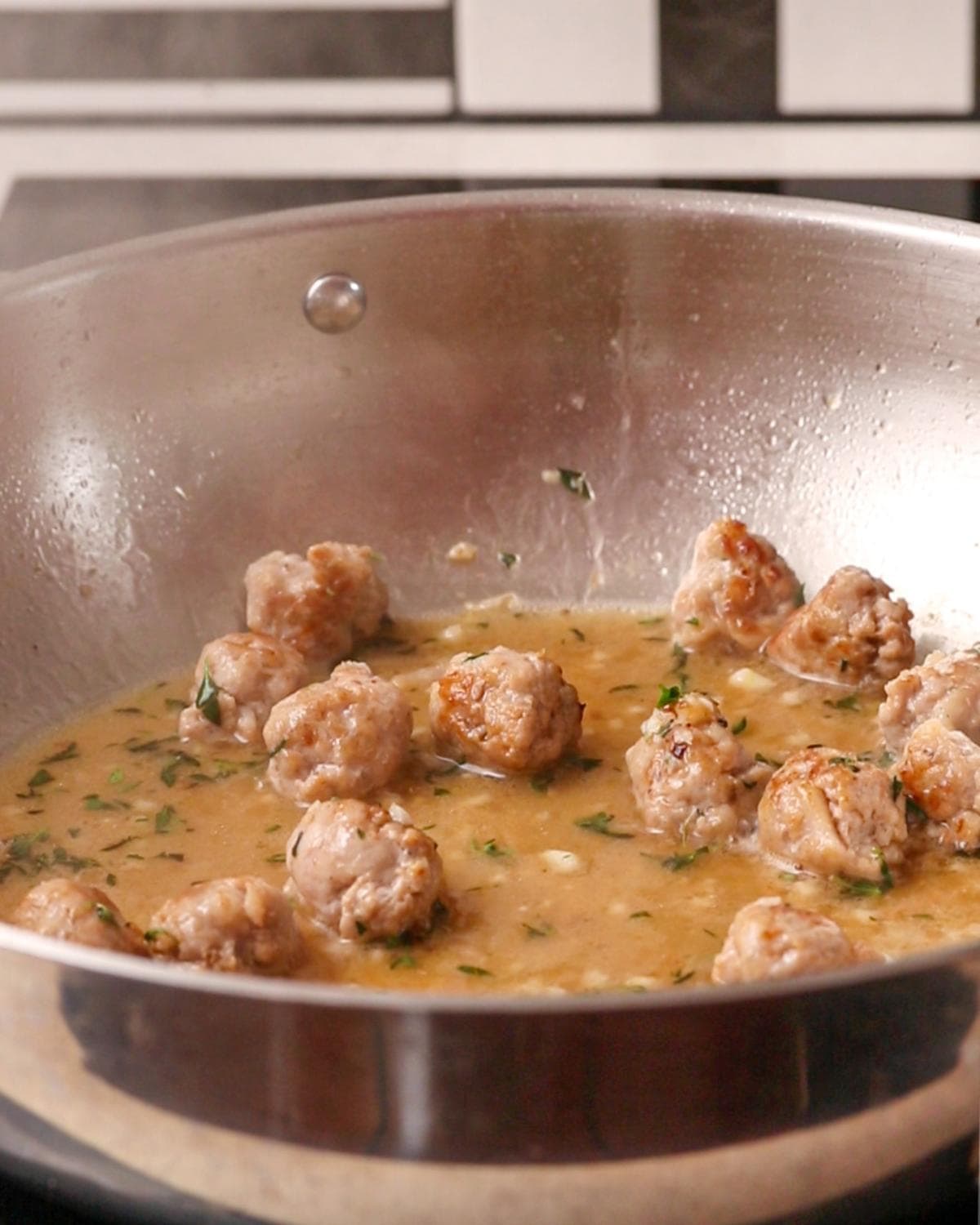 Wine simmering in the pan with the sausage.