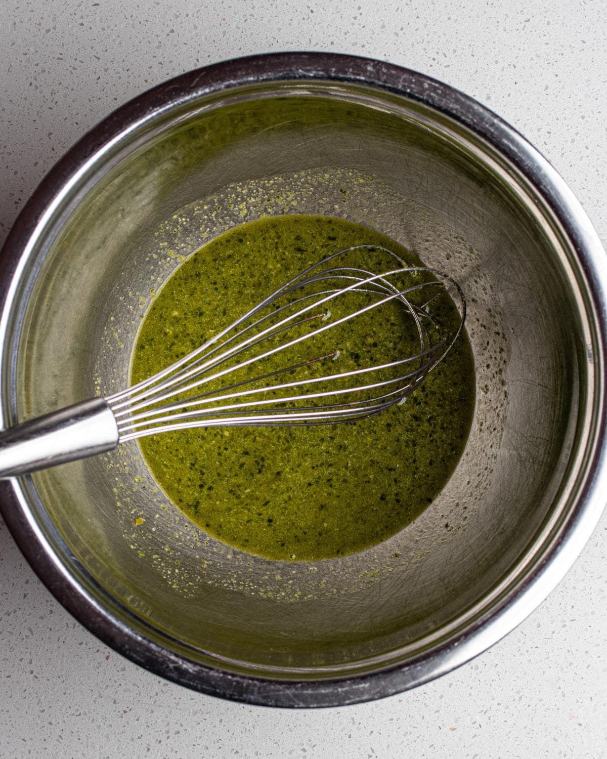 Pesto mixed with pasta water to loosen into a smooth sauce.