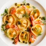 Salmon Ravioli in a cream sauce with flaked smoked salmon, capers and dill.