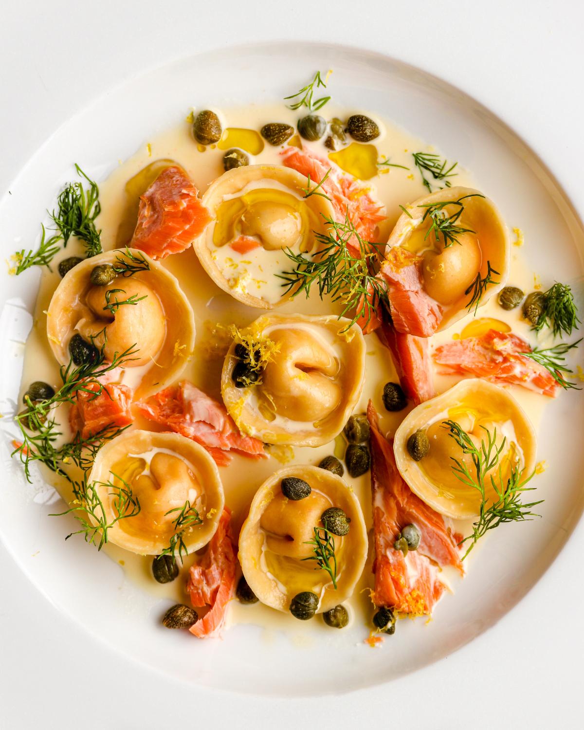 Salmon Ravioli in a cream sauce with flaked smoked salmon, capers and dill.