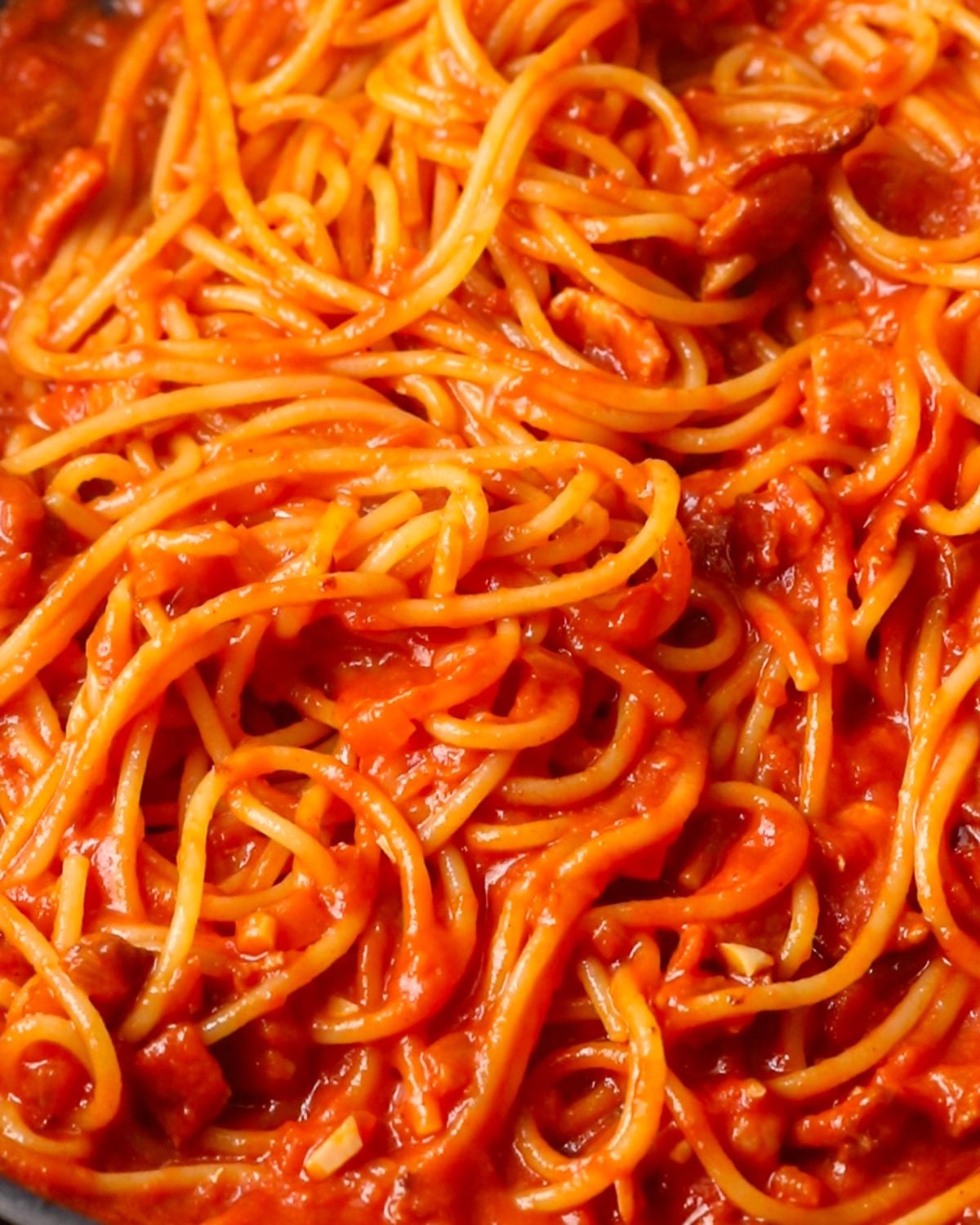 Cooked spaghetti tossed through the sauce.