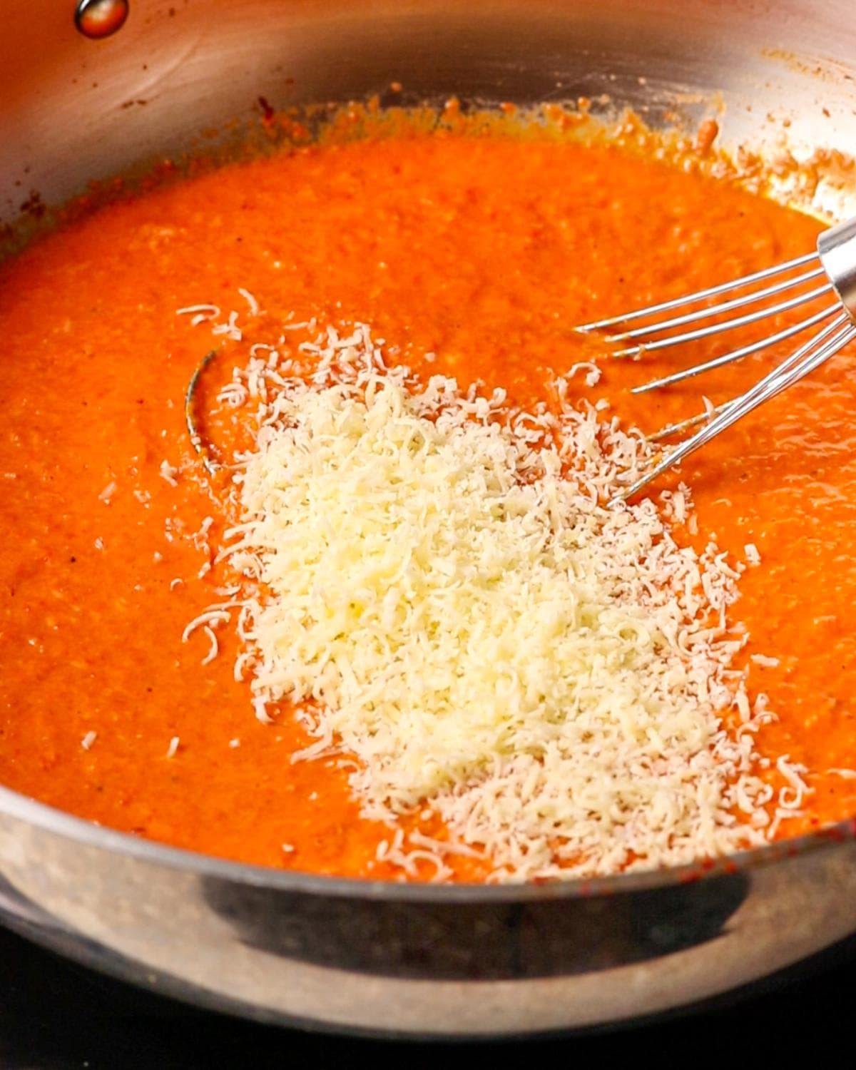 Heavy cream and grated parmesan stirred into the roasted red pepper sauce.