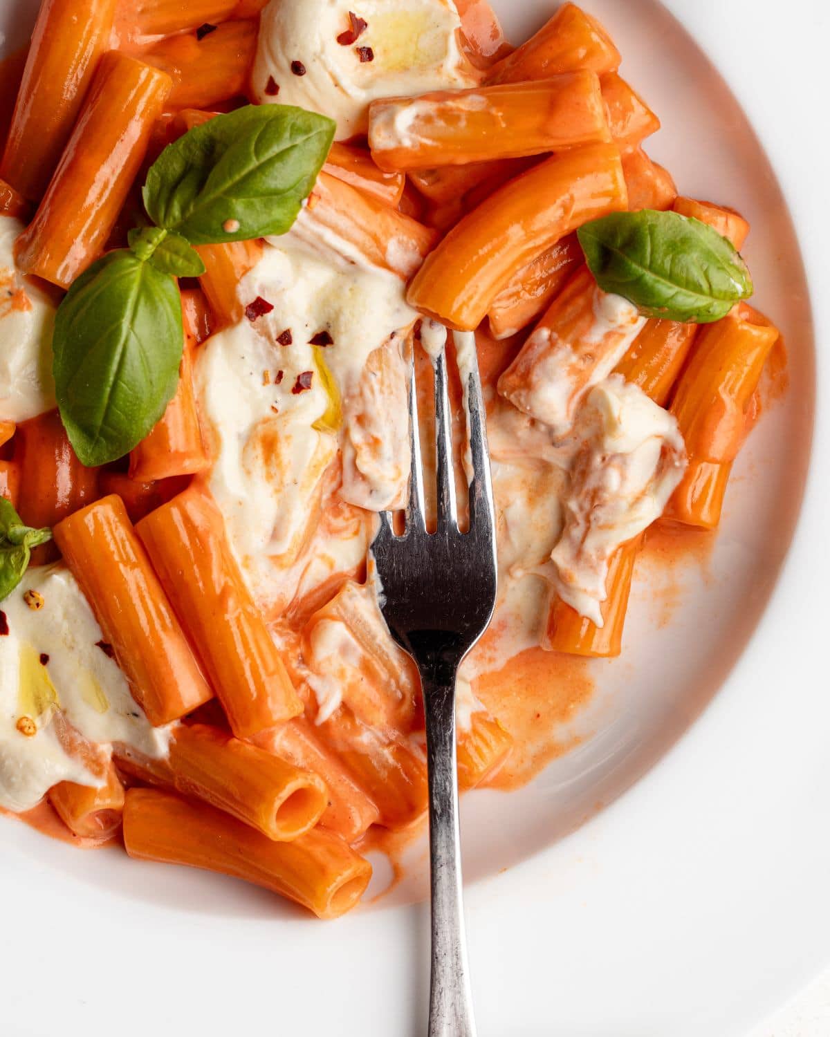 Creamy tomato pasta with whipped feta dolloped on top.