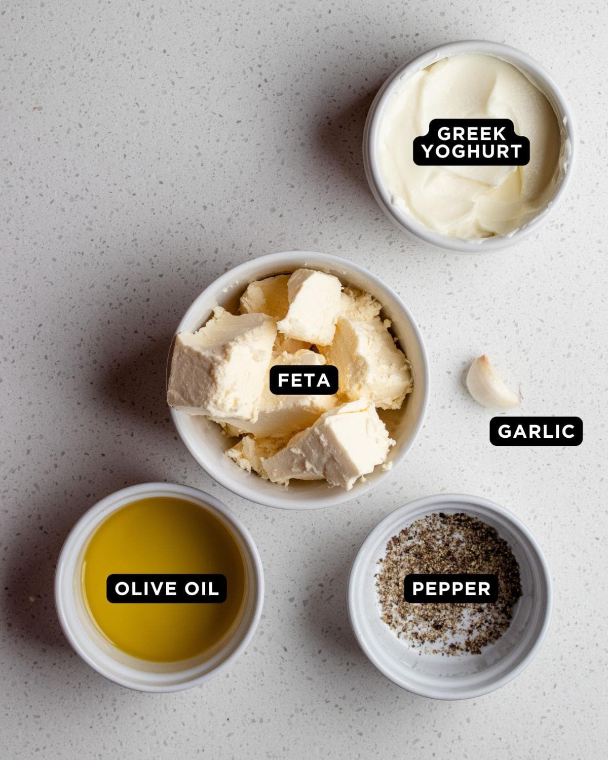 Ingredients in ramekins on a bench top.