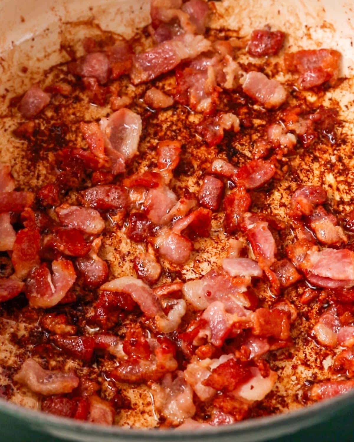 Bacon sizzling in a Dutch oven.