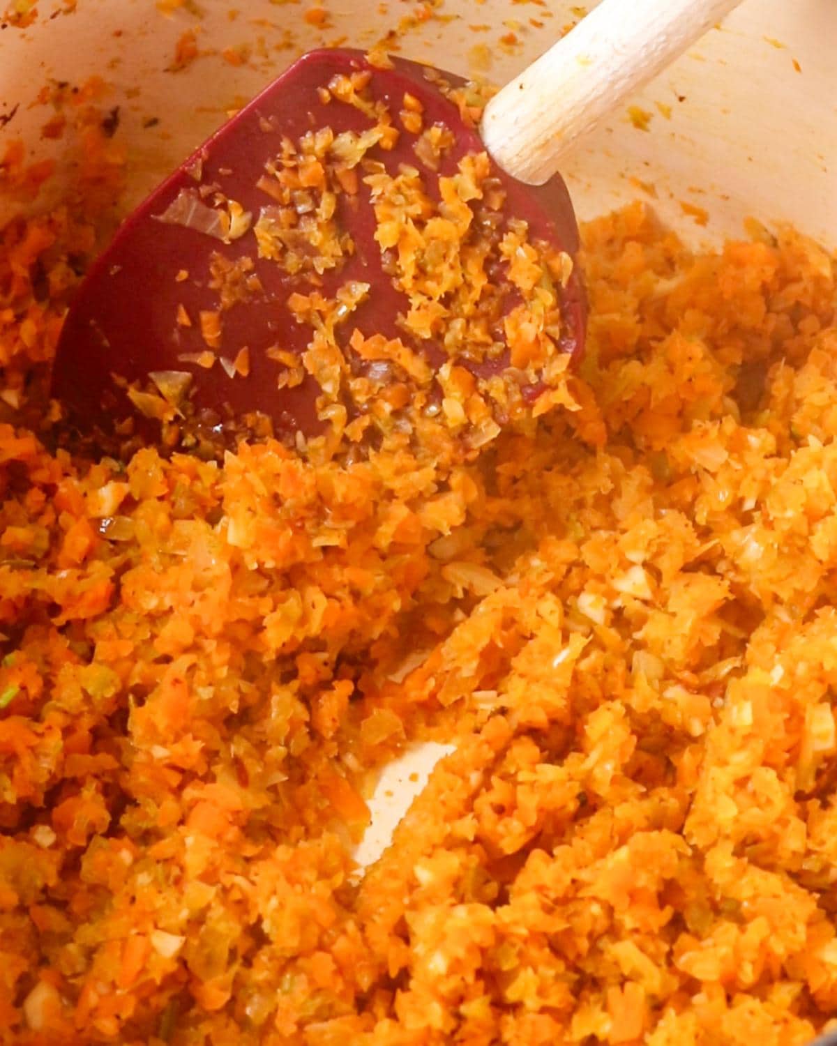 Diced onion, carrot, celery and bacon cooking in a Dutch oven for beef ragu.