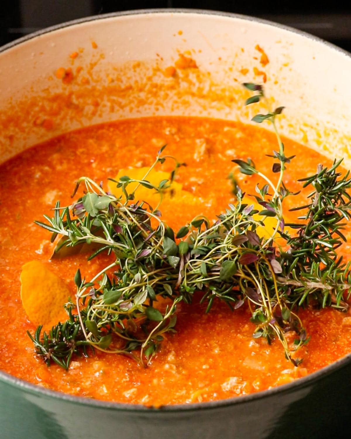 Tomatoes, stock, milk and fresh herbs added before simmering.