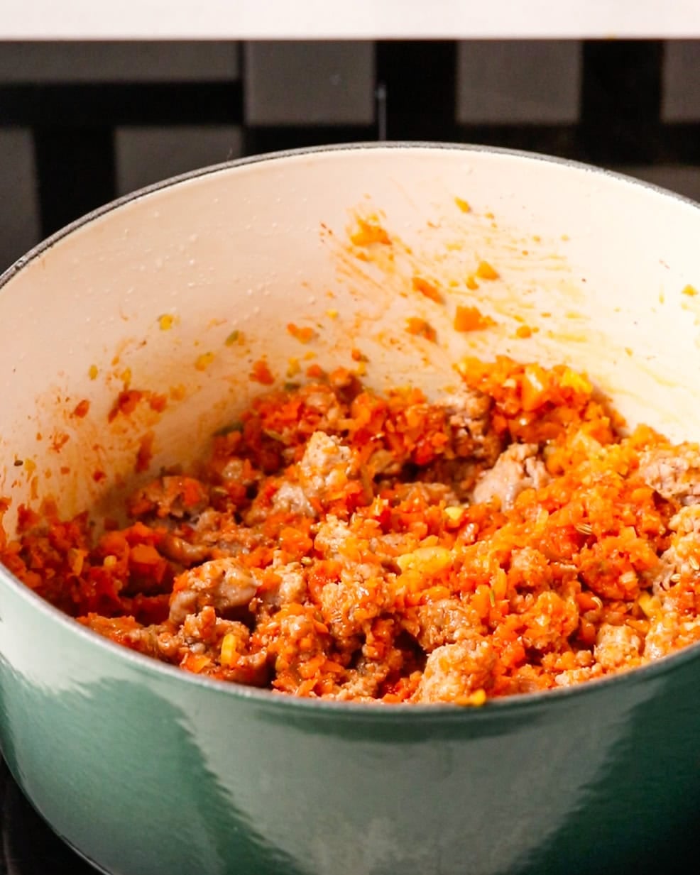 Browned sausage meat stirred back into the soffritto.