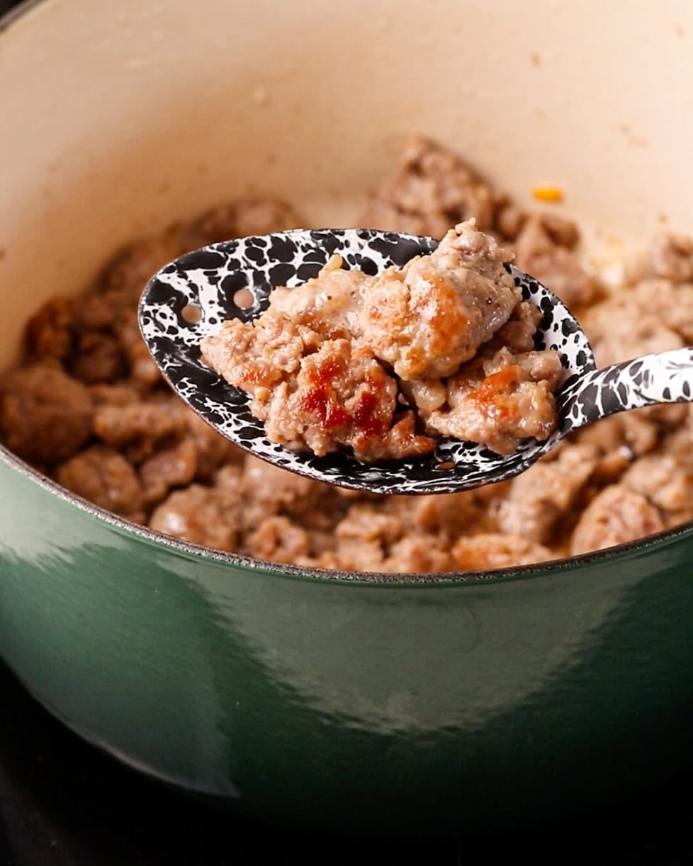 Browning sausage meat in a Dutch oven.