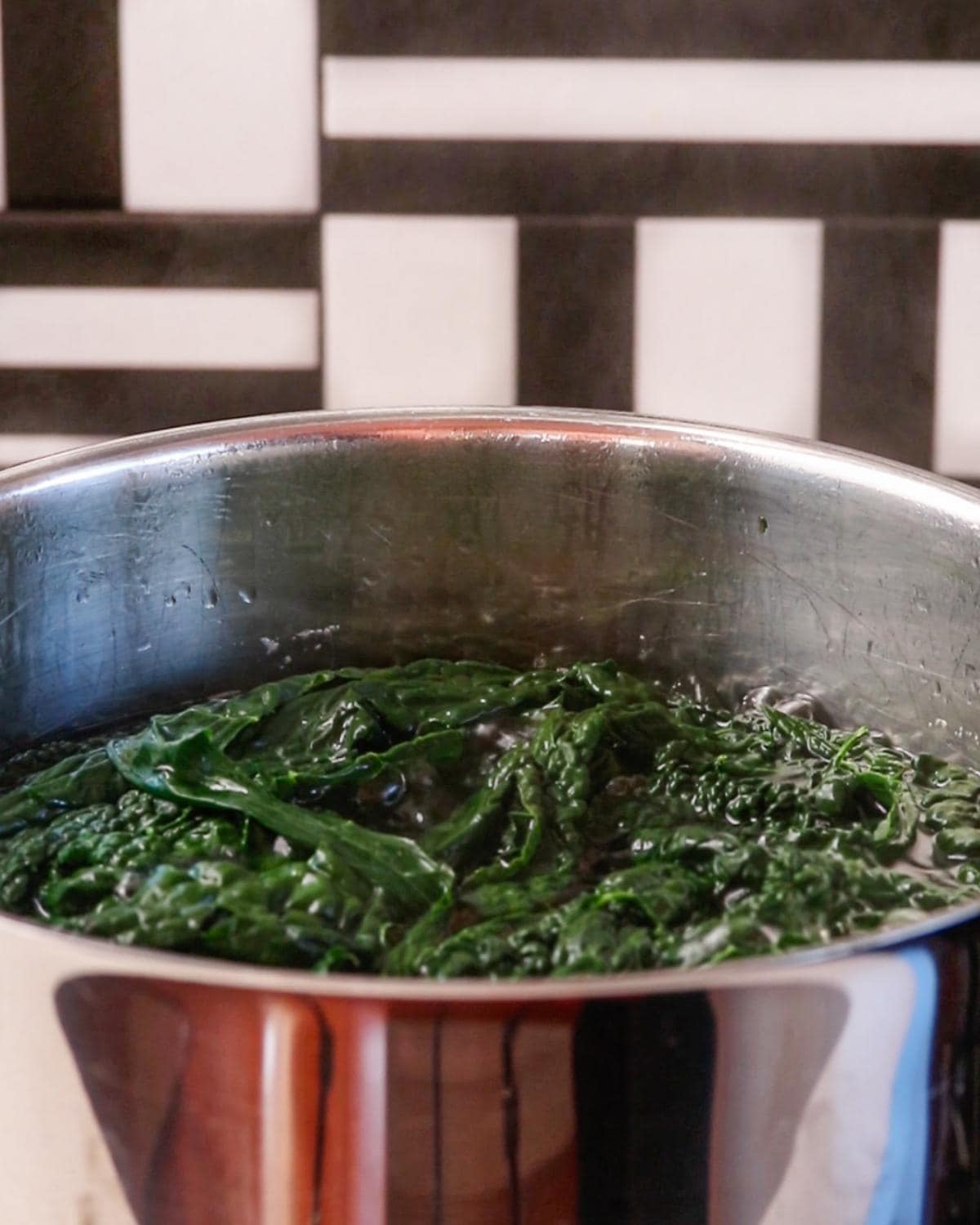 Cavolo nero and garlic blanching in a pot of water.