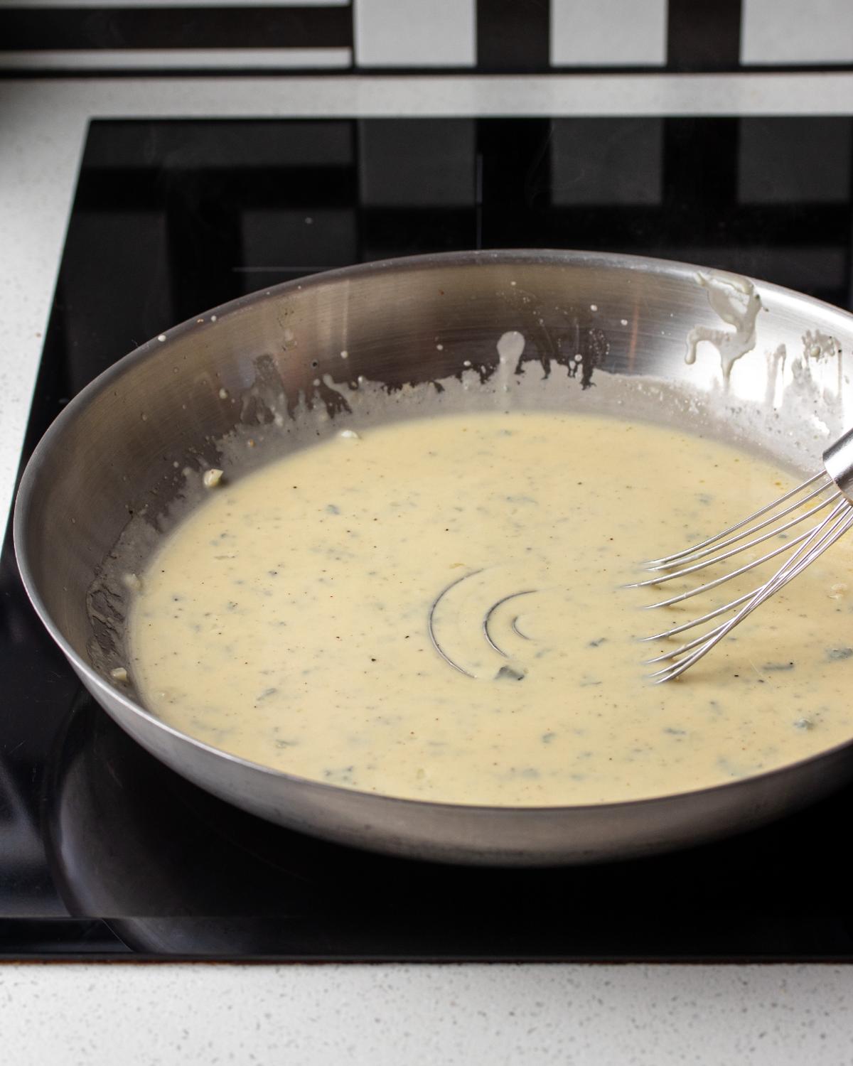 Smooth and creamy gorgonzola pasta sauce in a skillet before adding the cooked pasta.