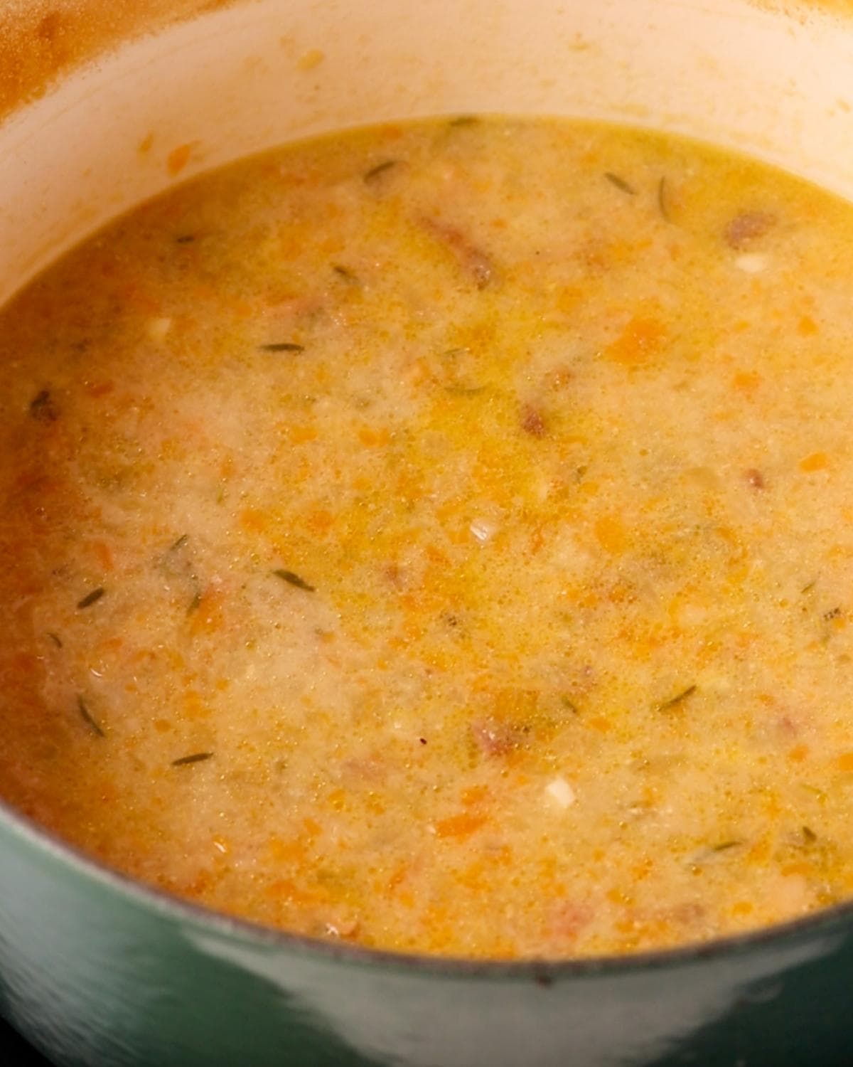Braising liquid simmering on the stove top.