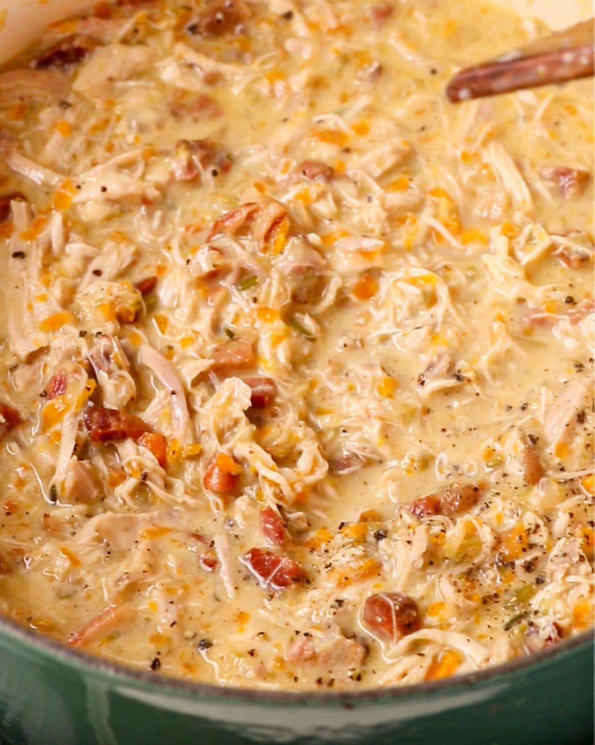 Shredded chicken stirred through the finished rich chicken ragu sauce.
